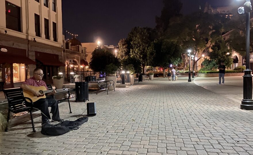 A street musician plays for the occasional passerby in downtown Riverside, Calif. [Credit: Sonya Singh]