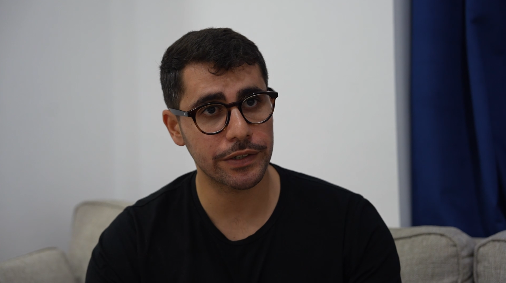 Aly Elbedewy talking on his couch